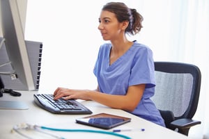 nurse working at a computer